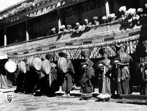 Lamas performing on traditional instruments as a prelude to a ceremony. Film still, mid-20th century
