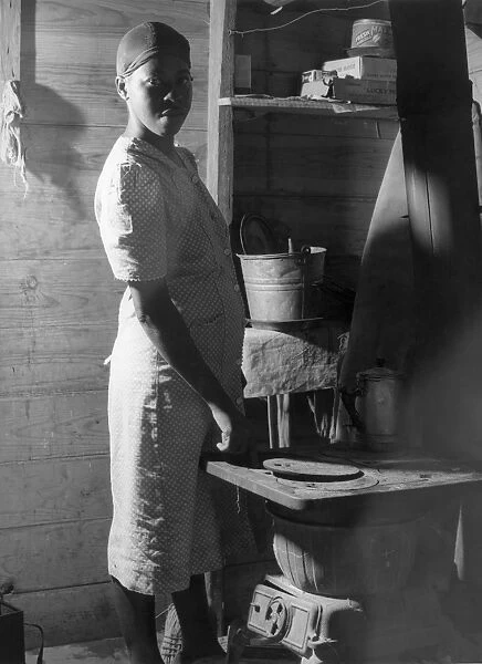 MIGRANT WORKER, 1940. A migrant worker in the windowless cabin where she lives