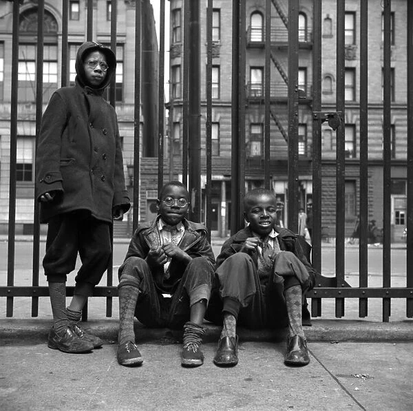 NEW YORK: HARLEM, 1943. Three boys on the sidewalk in Harlem, New York City