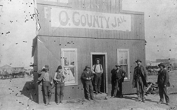 OKLAHOMA: JAILHOUSE, c1893. A group of men standing in front of the first jailhouse in Enid