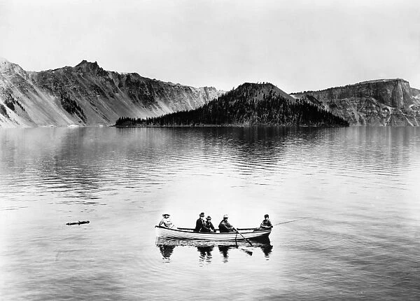 OREGON: CRATER LAKE, c1912. A group of people on a rowboat in the middle of Crater Lake with Wizards Island in the background, Crater Lake National Park, Oregon. Photograph, c1912