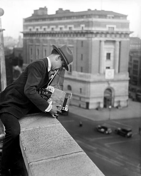PHOTOGRAPHER, c1915. A photographer with his camera on a rooftop in Washington, D