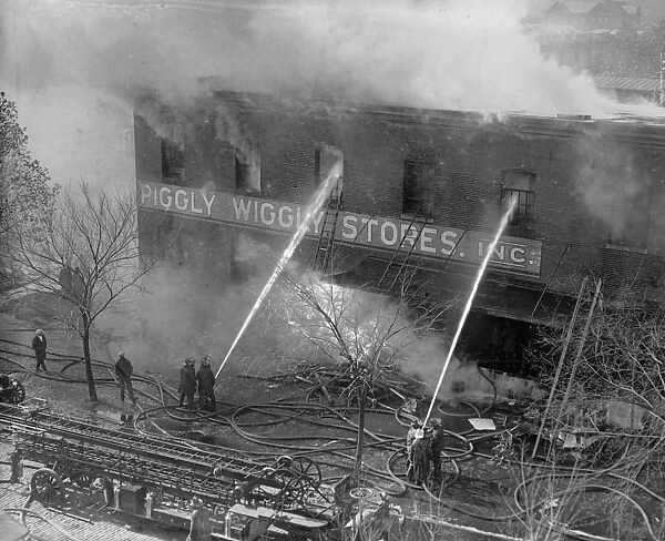 PIGGLY WIGGLY FIRE, 1923. Firefighters battling a fire at a Piggly-Wiggly self-service