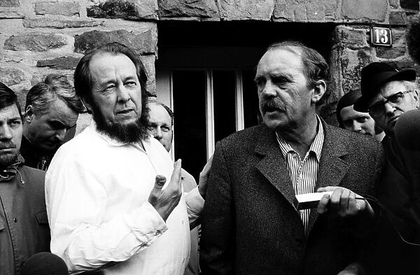 SOLZHENITSYN AND BÖLL, 1974. Russian writer Alexander Solzehnitsyn (left) and German writer Heinrich Böll photographed outside Bölls residence in Langenbroich, West Germany, February 1974, following Solzhenitsyns exile from the Soviet Union