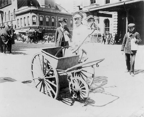 STREET SWEEPER, c1896. A street sweeper with a handcart in New York City
