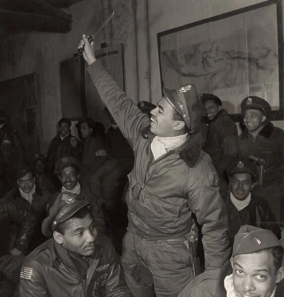 TUSKEGEE AIRMEN, 1945. Members of the Tuskegee Airmen 332nd Fighter Group at a briefing at Ramitelli Airfield, Italy, March 1945. Photograph by Toni Frissell. First row, left to right: Gentry Barnes, Samuel Watts, Wendell Lucas. 2nd row: Harold Morris, John Porter, Joseph Chineworth. 3rd row: Unidentified, Wyrain Schell