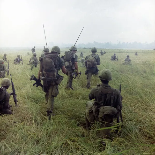 VIETNAM WAR, 1966. Members of the 101st Airborne Division moving across a rice