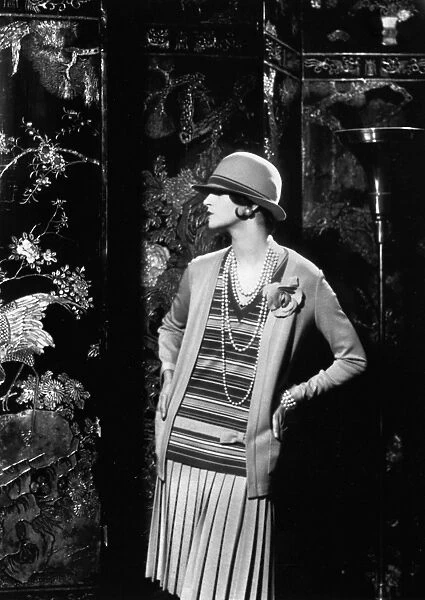 WOMENs FASHION, 1926. A model wearing an outfit designed by