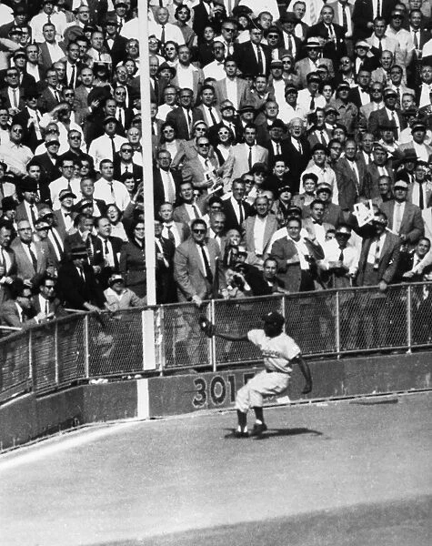 WORLD SERIES, 1955. Left fielder Sandy Amoros of the Brooklyn Dodgers catches a deep fly ball hit by Yogi Berra of the New York Yankees in the sixth inning of the seventh and deciding game of the 1955 World Series, at Yankee Stadium in the Bronx, New York City, 4 October 1955