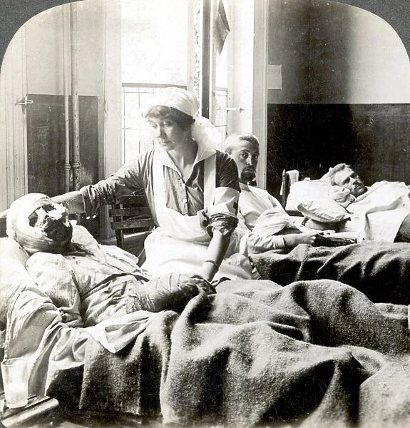 WORLD WAR I: NURSE. A nurse tending to a badly wounded