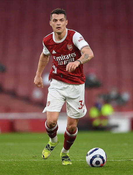 Arsenal's Granit Xhaka in Action: 2021 Premier League Match vs. Manchester City at Emirates Stadium (Behind Closed Doors)