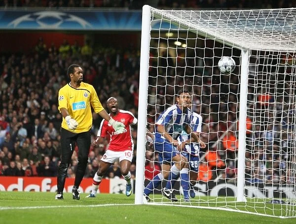 Porto goalkeeper Helton looks on as Emmanuel Adebayor s