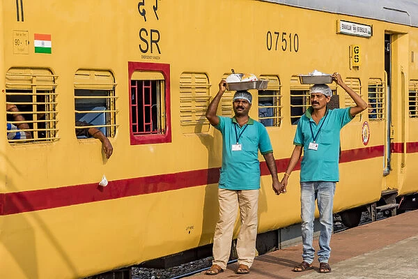 Two chefs get ready for the journey on the Indian Railway. This is at Kochi in Kerala, India