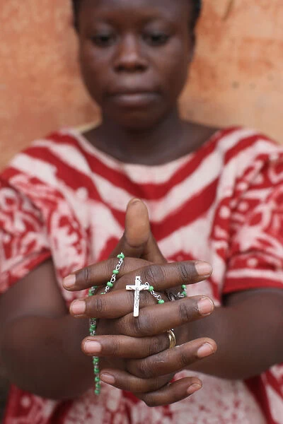 African woman praying the rosary