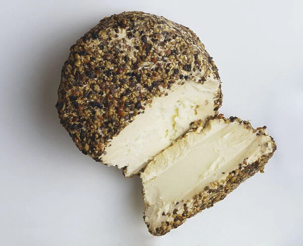 Boursin au Poivre, Round block of boursin, a white, smooth soft cheese with buttery texture, encrusted with a mixture of French herbs and peppers