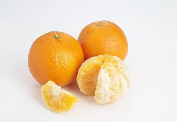 Clementine whole and peeled on white background