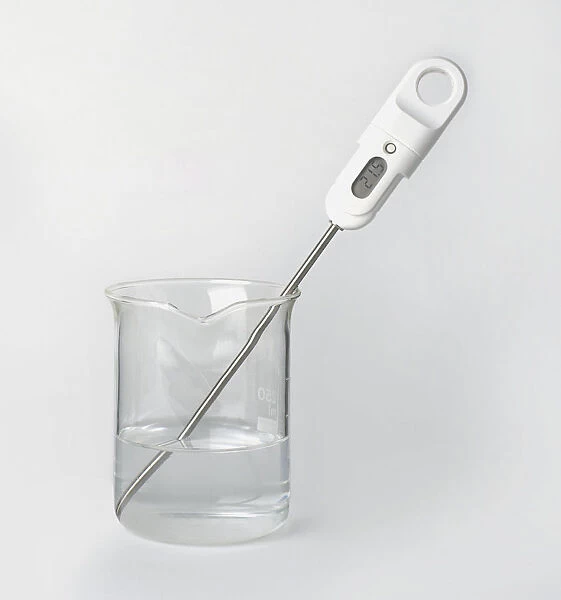 Digital thermometer in beaker of water, close-up available as