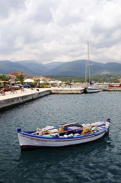 Greece, Greek Islands, Sami, small fishing boat in harbour with mountains in background