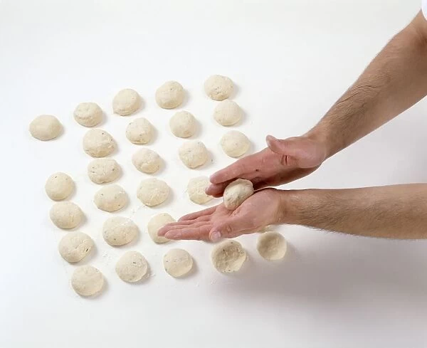 Hand rolling potato and chive bread dough balls