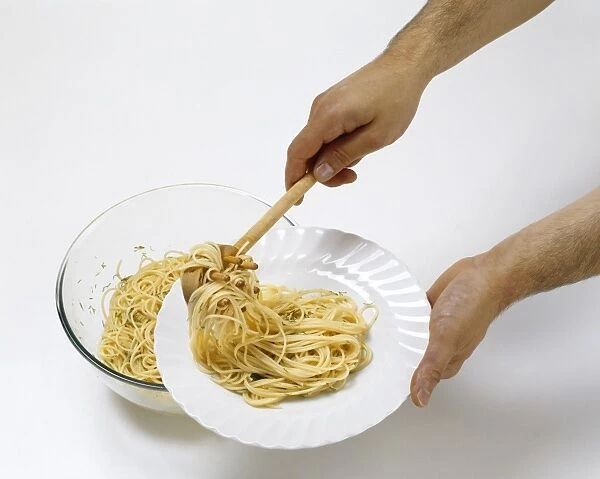 Man using wooden pasta ladle to serve cooked spaghetti on white plate