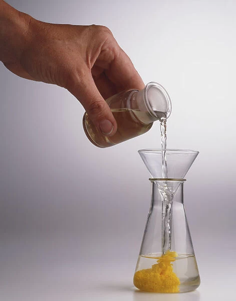 Pouring liquid into flask, causing percipitate reaction