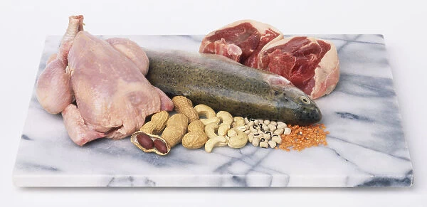 Selection of foods rich in zinc, including raw chicken, fish, meat steaks, nuts and pulses