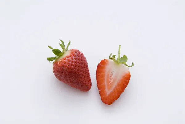 One strawberry and half strawberry, close-up