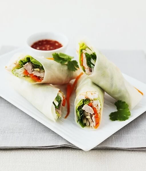 Vietnamese spring rolls with sweet and spicy dipping sauce. Rolls contain pork and prawns