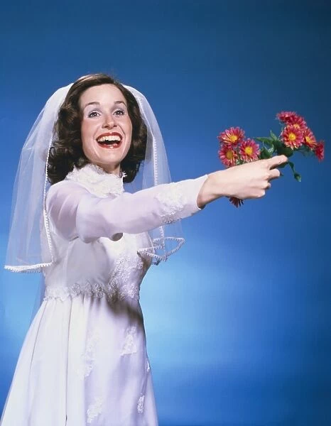 Vintage portrait of a bride throwing her bouquet