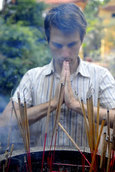 Westerner praying in a Vietnam temple
