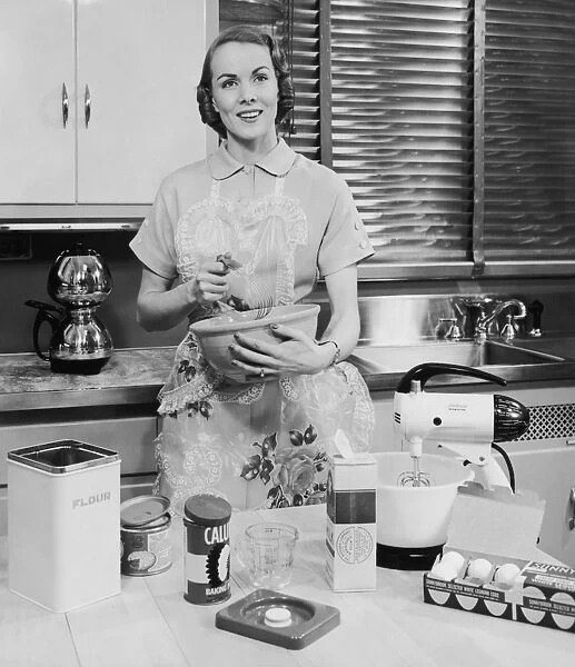 Woman with apron baking in her kitchen
