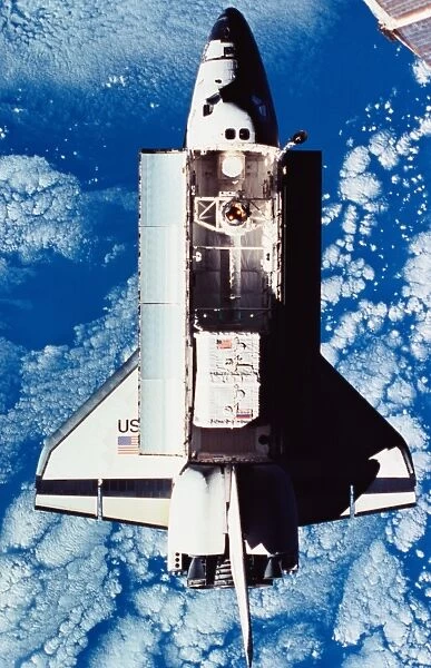 Elevated view of the space shuttle orbiting above the earth #13495003