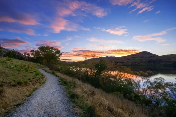 Sunset View Of Lake Wakatipu With Surrounding Mountains