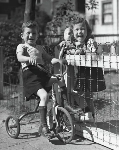 Boy on tricycle w  /  girl