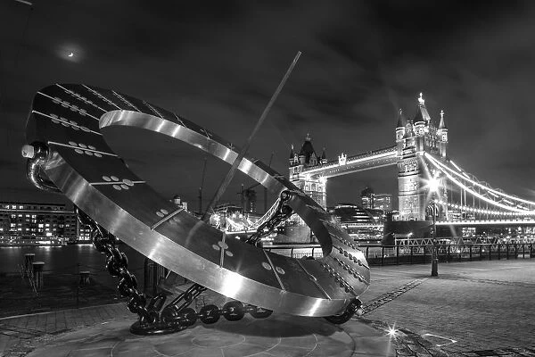 Dazzling. UK, London, view to illuminated Tower Bridge at night. Mono