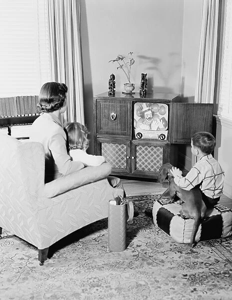 Mother and children watching television