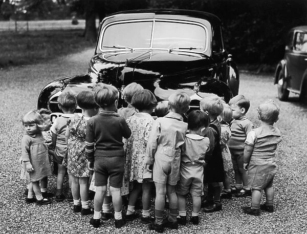 Nosey Kids. 10th August 1942: Nursery school children gather round a Chrysler
