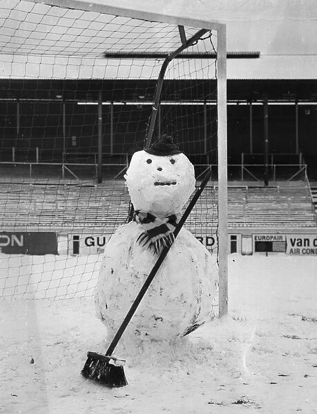 Snowman. A snowman built in front of a goal post. (Photo by Central Press / Getty Images)