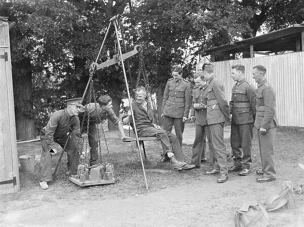 Territorial Army recruits at camp in Chichester, Sussex. Weighing machine. 1939