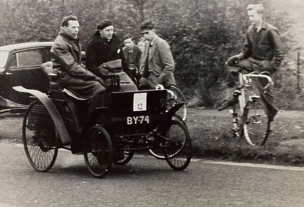 Antique race car, manufactured by the 'Benz' company at the beginning of the 1900's, participates in the 'London-Brighton' race, driven by the contender R.S. Miles
