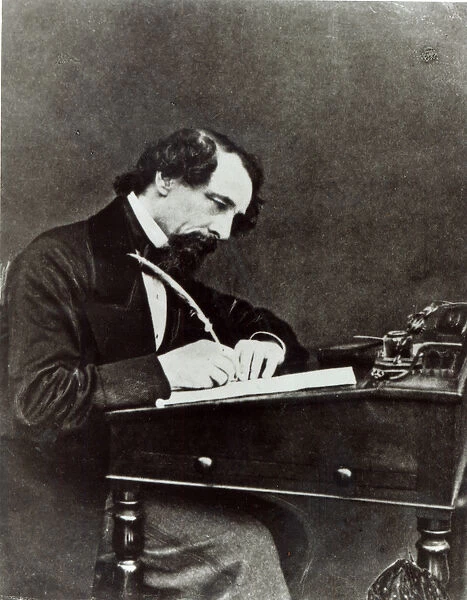 Charles Dickens (1812-70) at his desk, 1858 (b  /  w photo)
