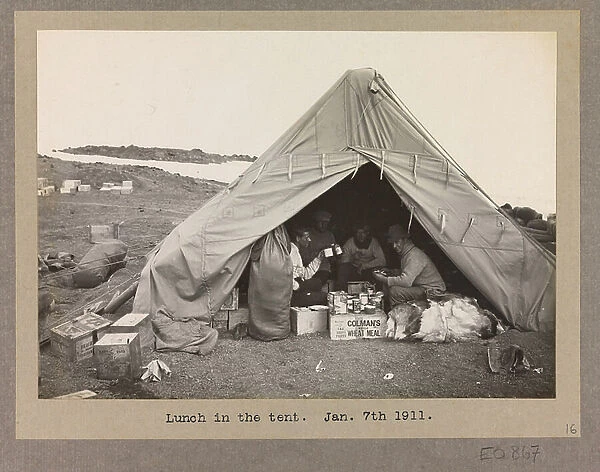 Four expedition members having lunch in a tent, 1911 (b / w photo)