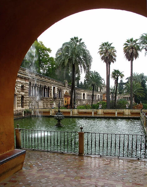 Fountain and basin in the gardens of the fortified palace of the Alcazar of Seville (Spain)