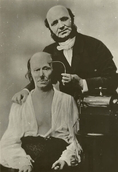 French neurologist Duchenne de Boulogne using his electrophysiology apparatus on an old man, 1862 (b  /  w photo)