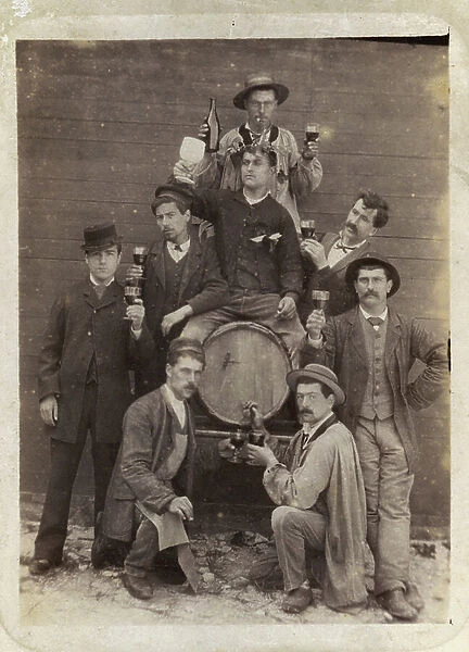 A group of drinkers around a barrel with a bottle and glasses and a man sitting a caliphourchon on a parodiant barrel Bacchus, 1870