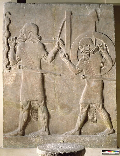 Relief depicting two soldiers carrying the kings war chariot
