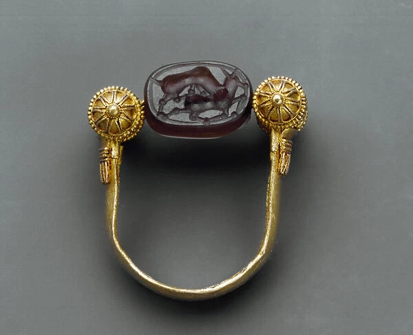 Ring with the small cylinders hold a hinge around which a scarab in engraved onyx