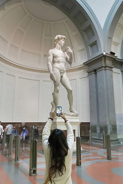Taking a photo in front of the statue of David by Michelangelo