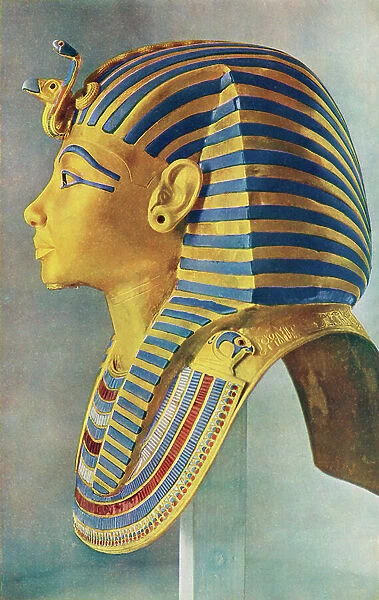 Tutankhamun. The solid gold portrait mask which covered the head of the young Pharaoh's Mummy. Egyptian pharaoh of the 18th dynasty, ruled c. 1332 BC - 1323 BC. From The Illustrated London News, Silver Jubilee Record Number, 1910 - 1935