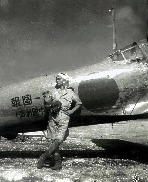 World War II,Japanese pilot poses by Zero fighter in the South Pacific
